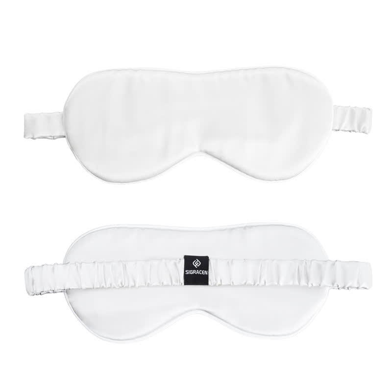 A white mulberry silk sleep mask set with elastic straps and a logo on one side. Mulberry Silk Sleep Mask Set - Image 1