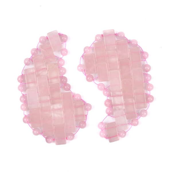 Rose quartz eye patches in soft pink hues, featuring a textured design of beads and geometric shapes. Rose Quartz Jade Eye Patch - Image 1