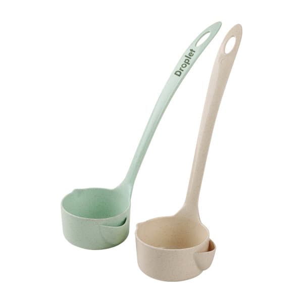 A set of two promotional wheat straw oil filter spoons in light green and beige, featuring branding on the handle. Promotional Wheat Straw Oil Filter Spoon - Image 1