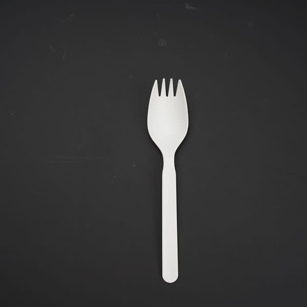 A white disposable spork on a black background, featuring a combination of spoon and fork designs. Promotional Eco Friendly Disposable Spork - Image 1
