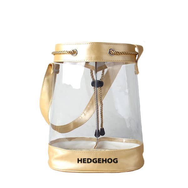 A gold and clear PVC drawstring gift bag with a strap and a logo. Gold Clear PVC Drawstring Gift Bag - Image 1