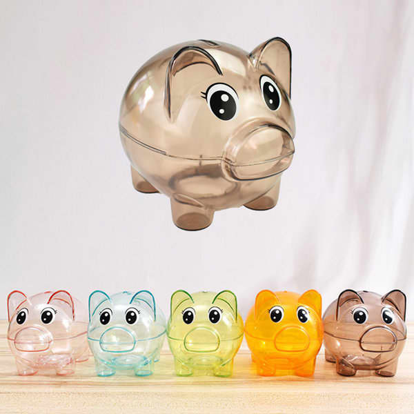 Clear plastic piggy banks in various colours: blue, green, orange, and a translucent brown. Each features a cute face and a logo. Clear Plastic Piggy Bank - Image 1