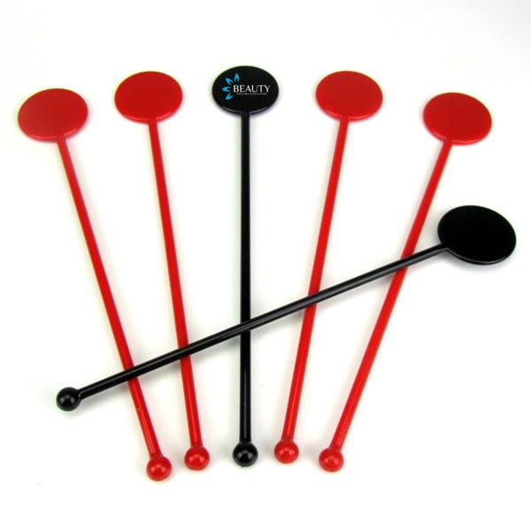 Customisable plastic swizzle sticks in red and black, featuring circular tops and a logo on one stick. Customizable Plastic Swizzle Sticks - Image 1