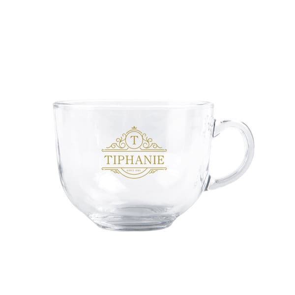 A glass wide mouth coffee mug with a handle, featuring a logo in gold. Clear and elegant design. 16 oz. Glass Wide Mouth Coffee Mug - Image 1