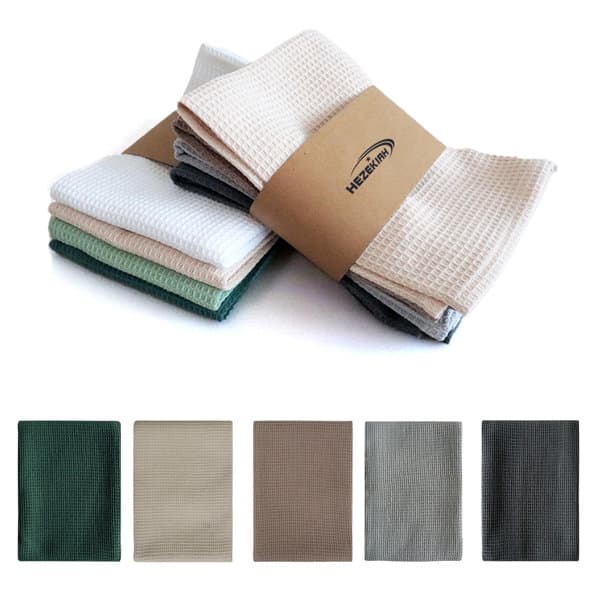 A set of cotton waffle absorbent kitchen cloths in various colours, stacked and wrapped with a branded band. Cotton Waffle Absorbent Kitchen Cloth - Image 1