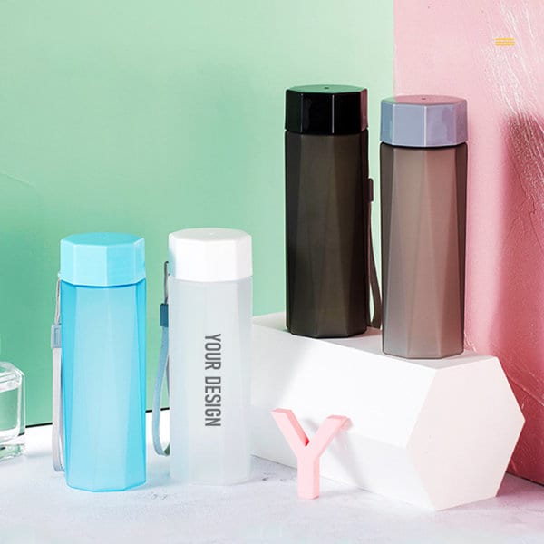 A drink bottle collection featuring frosted finishes in blue, black, grey, and clear, with a logo present on one. On The Go Frosted Water Bottle - Image 1