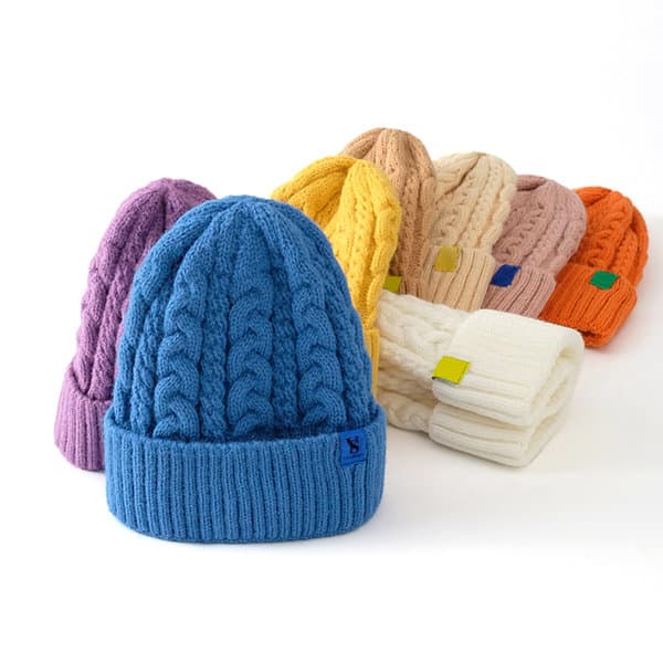 A collection of vibrant adult cable knit beanies in blue, purple, yellow, pink, orange, and cream, featuring various logos. Adult Cable Knit Beanie - Image 1