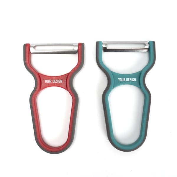 A plastic peeler with ergonomic handles, featuring red and teal colours, and a logo area for custom design. Plastic Peeler With Ergonomic Handle - Image 1
