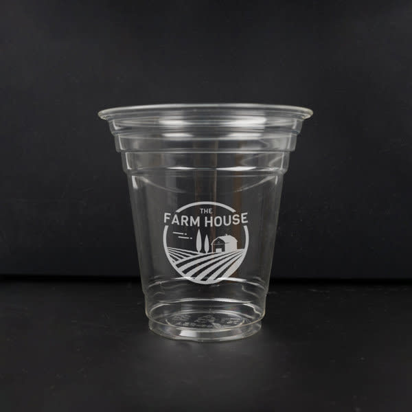 A clear 12 oz. biodegradable disposable PLA cup with a branded logo design. 12 oz. Biodegradable Disposable PLA Cup - Image 1