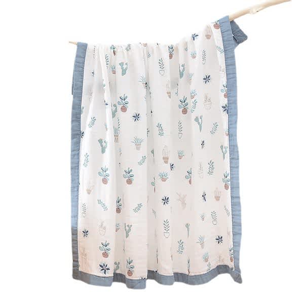 A bamboo cotton baby blanket featuring a light background with colourful plant and flower patterns, bordered in blue. 4 Layers Bamboo Cotton Baby Blanket - Image 1
