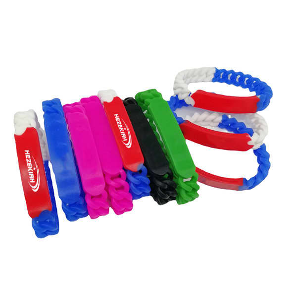 Several custom silicone twist bracelets in various colours, including pink, blue, green, black, and red, arranged together. Custom Silicone Twist Bracelet - Image 1