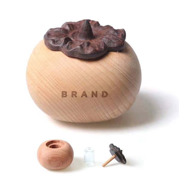 A persimmon-shaped aroma diffuser in wooden tones with a dark brown lid, featuring a small clear insert. Persimmon Shaped Aroma Diffuser - Image 1