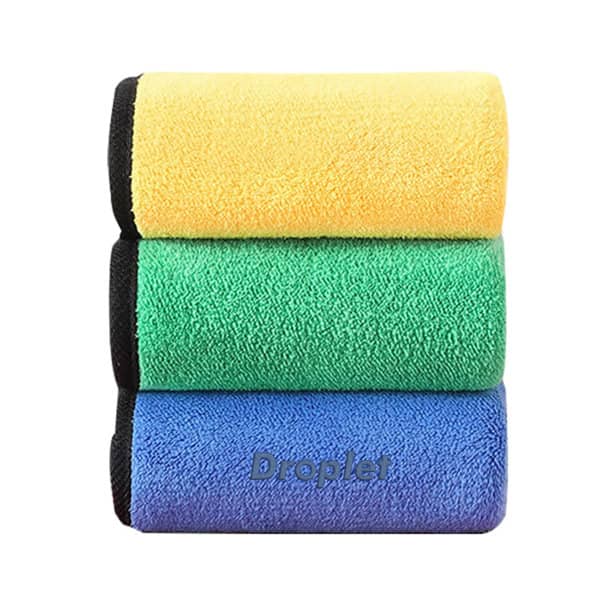 Three thickened coral velvet car cleaning cloths stacked, featuring yellow, green, and blue colours, with a branding logo visible. Thickened Coral Velvet Car Cleaning Cloth - Image 1