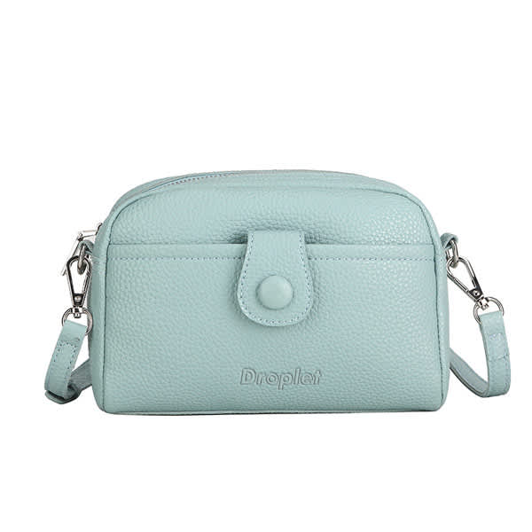 A small crossbody bag in mint green PU leather with a front pocket and adjustable strap. It features branding on the front. PU Leather Fashion Small Crossbody Bag - Image 1
