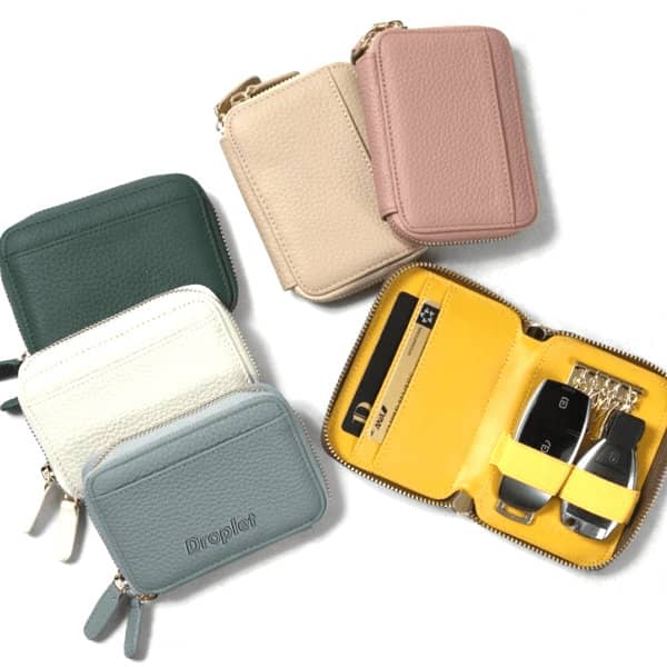 A range of Portable PU Key Holder Wallets in green, cream, beige, pink, and light blue, featuring a zippered design and interior compartments. Portable PU Key Holder Wallet - Image 1