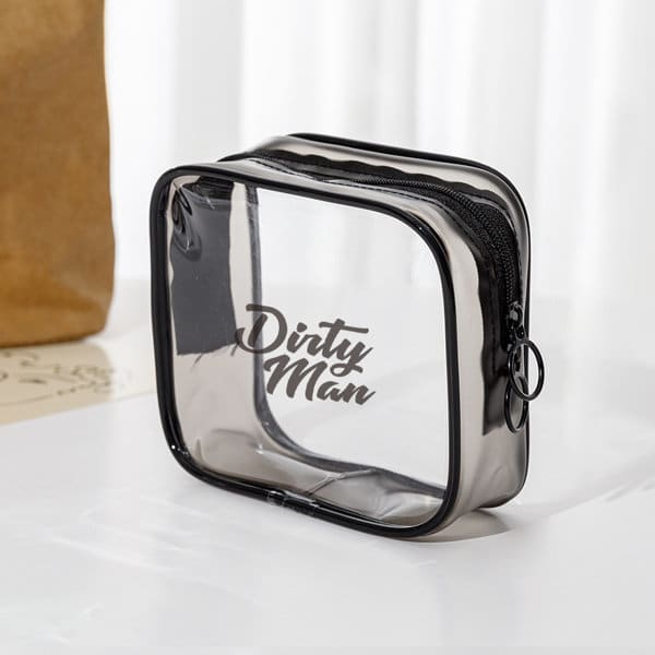 A small clear PVC zippered toiletry bag in black, featuring a branded logo on the front. Small Clear PVC Zippered Toiletry Bag - Image 1