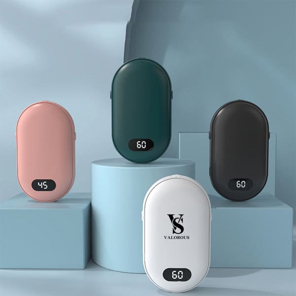 A collection of digital charging hand warmers in pink, green, black, and white, displayed on pastel pedestals. Digital Charging Hand Warmer - Image 1