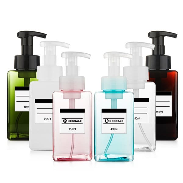 A drink bottle collection featuring six plastic pump bottles in green, white, pink, blue, and dark brown. Each includes a pump top and label. 16 oz. Plastic Pump Bottle - Image 1
