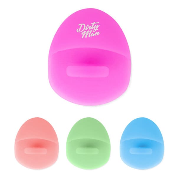A pink silicone facial cleaning pad with a smooth surface, alongside pads in peach, green, and blue. Features a logo. Silicone Facial Cleaning Pad - Image 1
