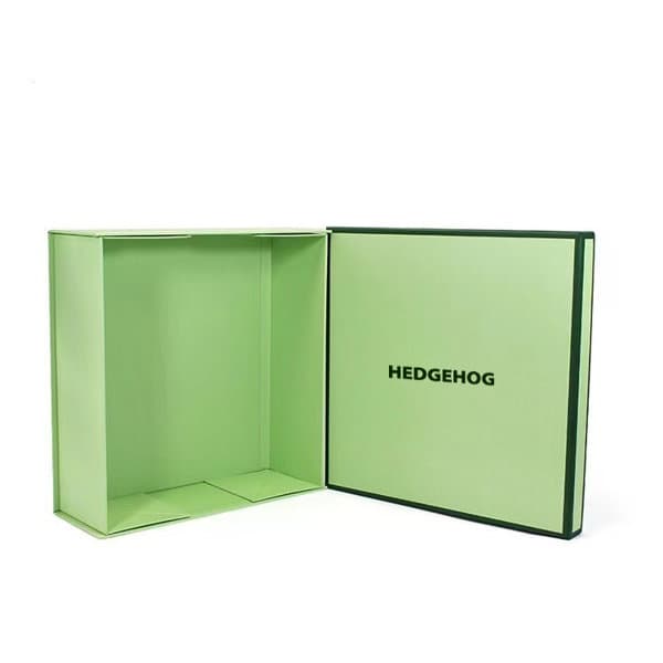 A square gift box with lid, featuring a light green exterior and a dark green trim. It has an interior space for storage. Square Nesting Gift Paper Box With Lid - Image 1