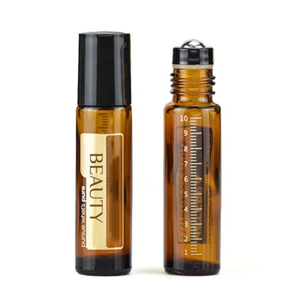 A 10ml essential oil roller bottle in amber glass with a black cap. Includes a measuring scale and a logo. 10ml Essential Oil Roller Bottle - Image 1
