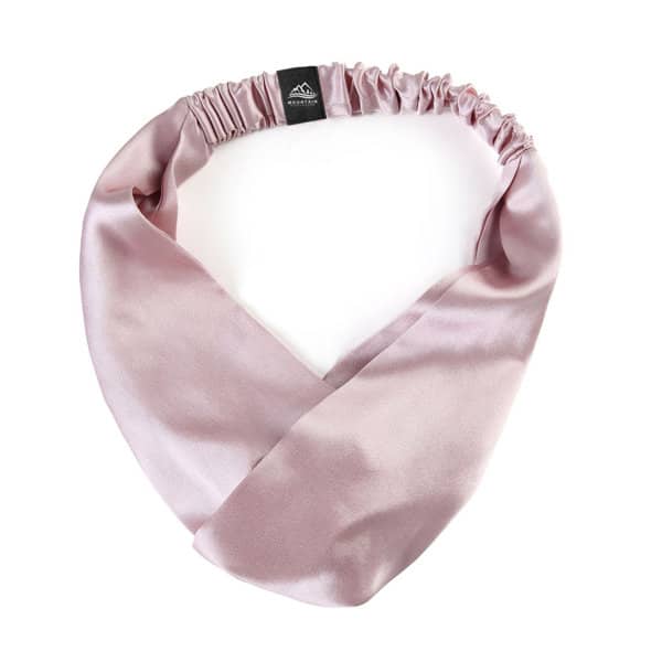 A 100% mulberry silk headband in a soft pink shade, featuring an elasticated design and a logo. 100% Mulberry Silk Head Band - Image 1