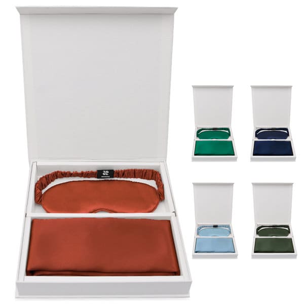 A gift set featuring a velvet pillowcase in rust and a matching eye mask, presented in a white box with various colours available. Pillowcase And Eye Mask Gift Set - Image 1