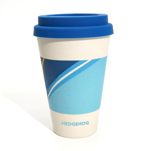 A coffee mug with a blue lid, featuring a blue and white design and a logo. 16.5 oz. Coffee Mug With Lid - Image 1
