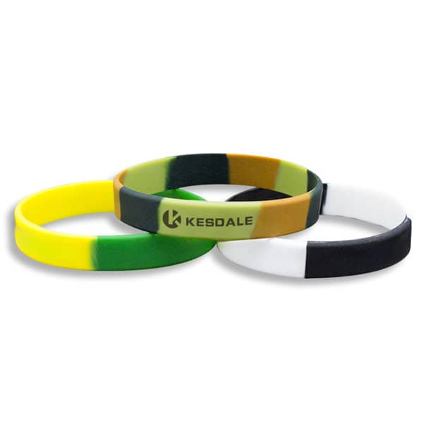 Custom silicone UV colour changing bracelets in green, yellow, brown, white, and black. The bracelets feature a logo. Custom Silicone UV Color Changing Bracelet - Image 1