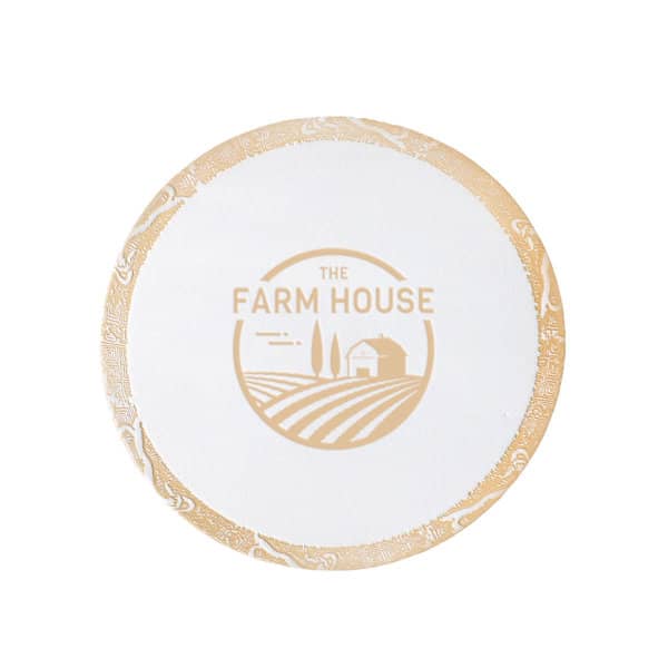 A round disposable coaster in white with a gold rim and a logo featuring a farmhouse and fields. Custom Disposable Coaster - Image 1