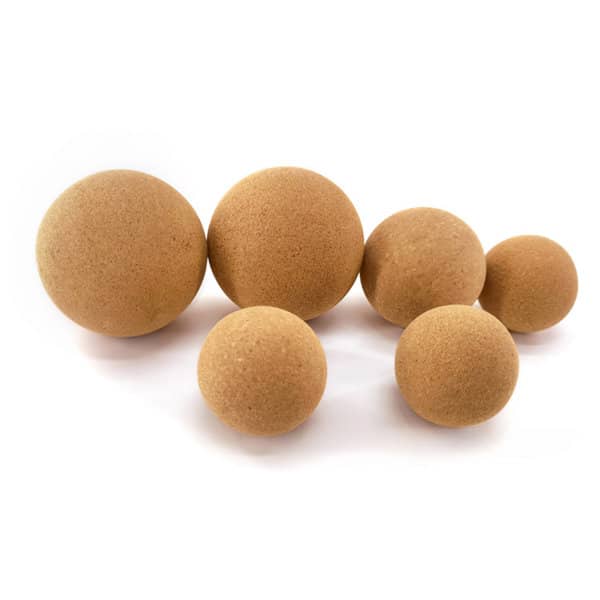 A set of tan cork balls in various sizes, featuring a smooth texture and a natural finish. Cork Yoga Massage Ball - Image 1