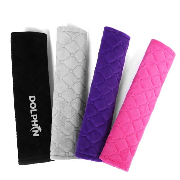 Car seat belt cover pads in black, grey, purple, and pink, featuring a logo on one pad. Car Seat Belt Cover Pads - Image 1
