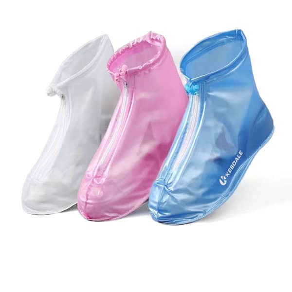 Three pairs of reusable waterproof shoe covers in white, pink, and blue, featuring zippers and a logo. Reusable Waterproof Shoe Cover - Image 1