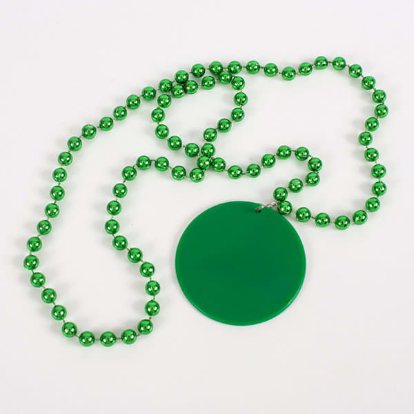 A green bead necklace featuring a large green medallion on a beaded chain. Mardi Gras Bead Necklace With Medallion - Image 1