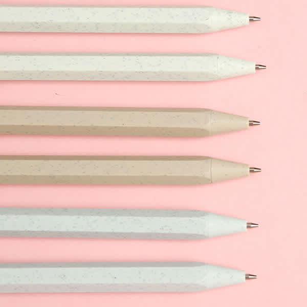 A collection of wheat straw mechanical pencils in light tones, displayed against a pink background. Wheat Straw Mechanical Pencil - Image 1