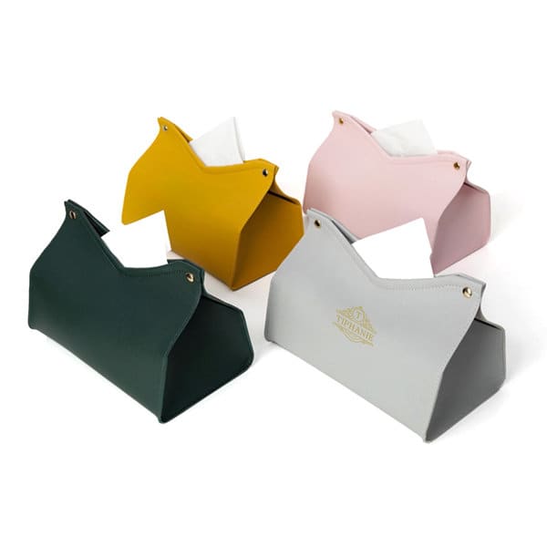 A set of four PVC leather tissue boxes in green, yellow, pink, and grey, featuring decorative logos. PVC Leather Tissue Box - Image 1