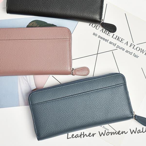 Three leather wallets in black, pink, and blue arranged on a flat surface with some printed materials underneath. Round Fastener Long Wallet - Image 1