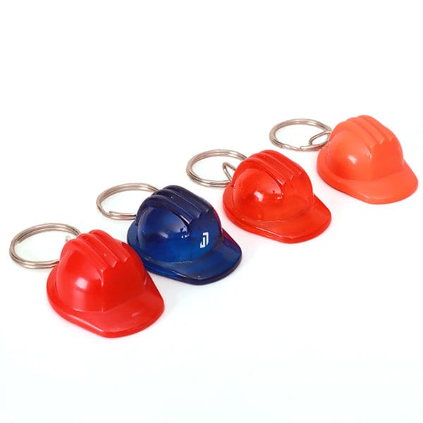 Four plastic safety helmet keychains in blue, red, and orange, each with a metal keyring attachment. Plastic Safety Helmet Keychain - Image 1