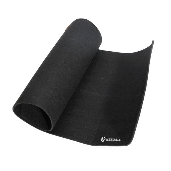 A large black felt desk pad is rolled slightly open, featuring a small logo on the corner. Large Felt Desk Pad - Image 1