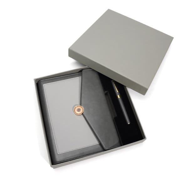 A grey spiral notebook gift set in an open box, featuring a pen and a black folder. Spiral Notebook Gift Set - Image 1