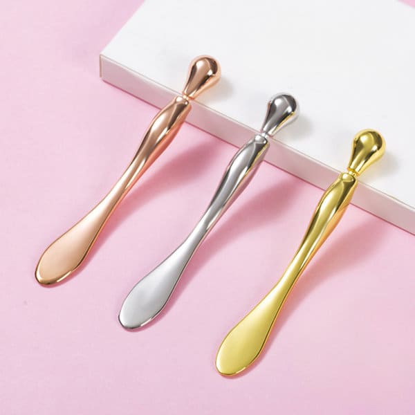 A set of three eye roller massage sticks in rose gold, silver, and gold, displayed on a light background. Zinc Alloy Eye Roller Massage Stick - Image 1