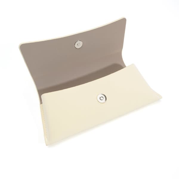 A hard shell eyeglasses case in cream with a soft beige interior, featuring a snap closure. Hard Shell Eyeglasses Case - Image 1