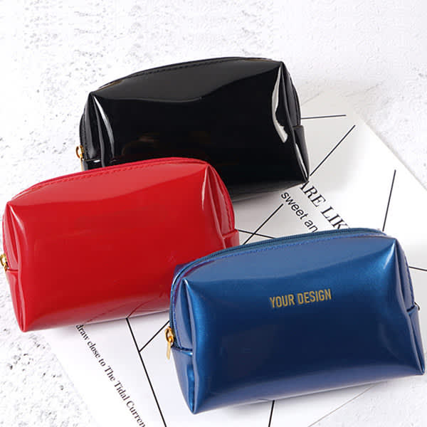 A set of three portable travel makeup bags in black, red, and blue, featuring a branding logo on the blue bag. Portable Travel Makeup Bag - Image 1