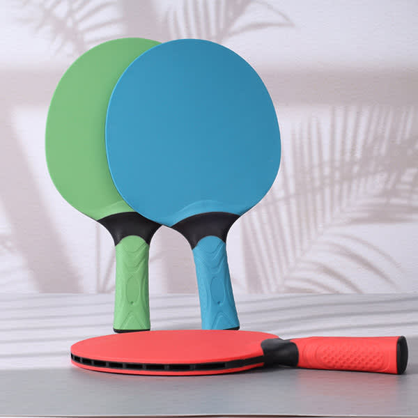 Custom table tennis rackets in blue, green, and red, featuring textured black grips and a sleek design. Custom Table Tennis Racket - Image 1