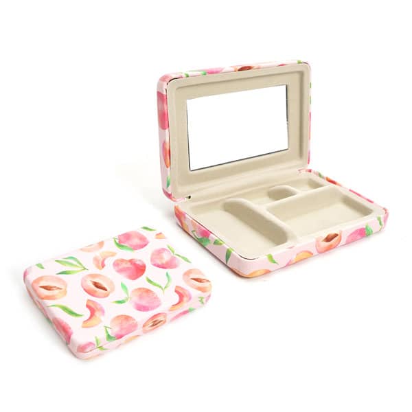 A travel jewelry box with a floral design, featuring a mirror and compartments inside, in shades of pink and cream. Travel Jewelry Box With Mirror - Image 1