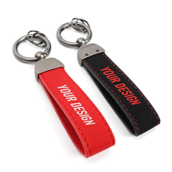 A custom car keychain featuring a red and a black strap with a metal ring, both displaying placeholder design text. Custom Car Keychain With Ring - Image 1