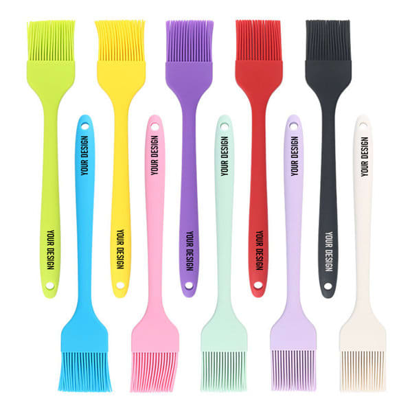 A collection of 10-inch silicone basting brushes in various colours, including yellow, purple, red, and blue, with branding. 10 Inch Silicone Basting Brush - Image 1