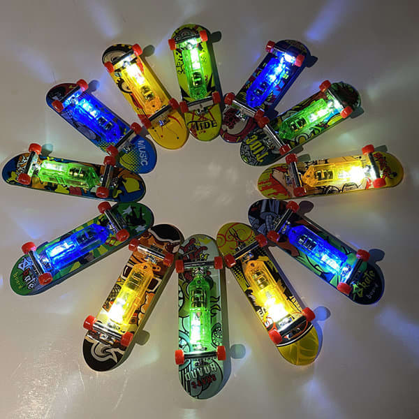 A collection of mini finger skateboards in various colours, featuring light-up designs arranged in a circular pattern. Custom Light-up Mini Finger Skateboards - Image 1