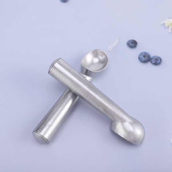 A nonstick aluminium ice cream scoop in a silver finish, placed on a light blue surface with scattered blueberries. Nonstick Aluminum Ice Cream Scoop - Image 1