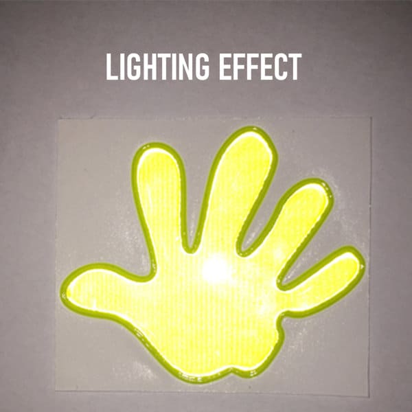 A reflective hand-shaped sticker in bright yellow with a glowing effect against a light background. Reflective Night High Visibility Stickers - Image 1
